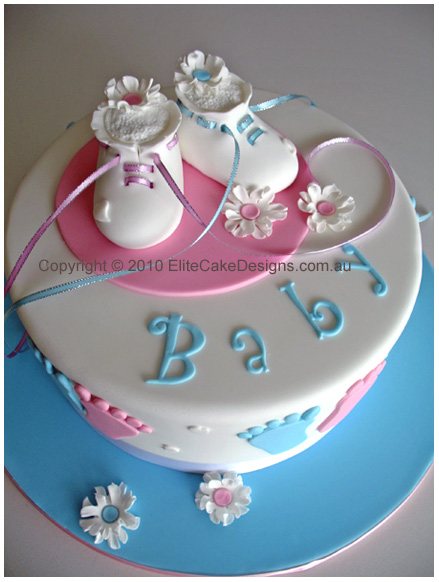 The popular white booties baby shower cake design.