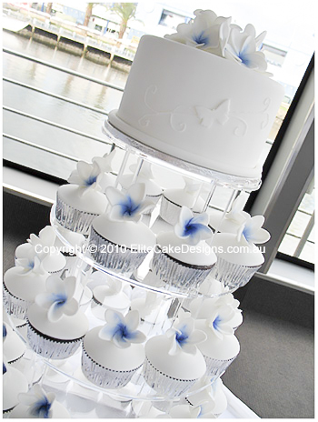 Beautifully designed frangipani cupcakes with cutting cake