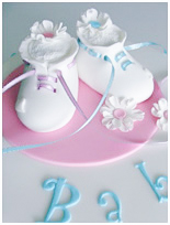 white booties baby shower cake
